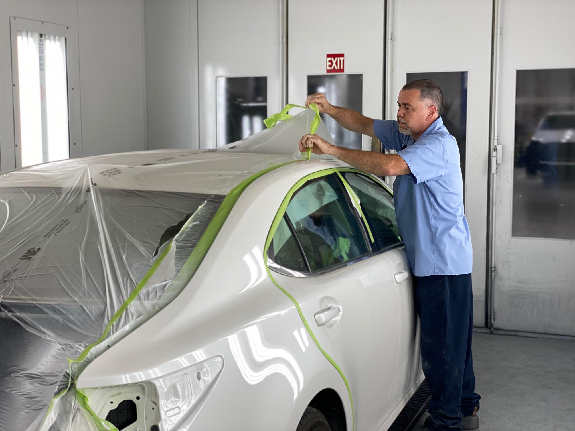 Putting painting wrap on a car.